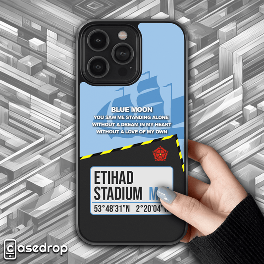 Front view of Manchester City football phone case featuring a sky blue design, Etihad Stadium address, and 'Blue Moon' lyrics for iPhone, Samsung & Google